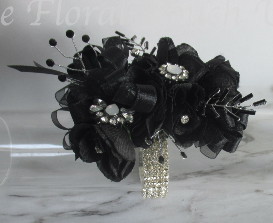 Black & Silver Wrist Corsage

Small black silk roses with embellishments and black crystal sprays & leaf sprays